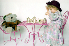 2 years old, having a teaparty with a teddy-bear